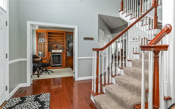 a view of entryway livingroom and hall with wooden floor