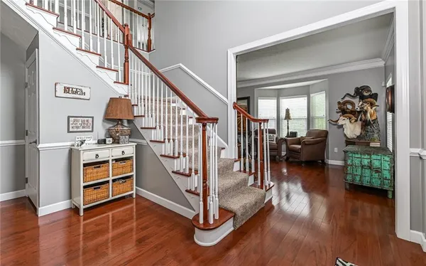 a kitchen with stainless steel appliances granite countertop dining table chairs sink and cabinets