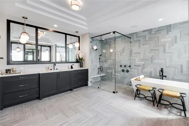 a spacious bathroom with a double vanity sink tub and shower