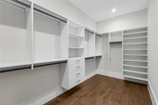 a view of walk in closet with empty racks