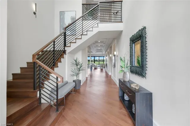 a view of entryway and hall with wooden floor