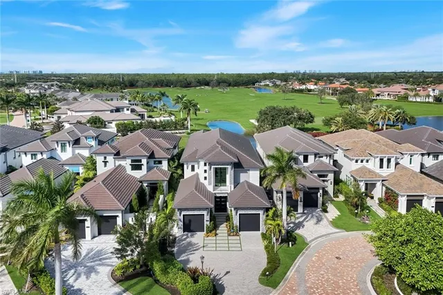 an aerial view of lake residential houses with outdoor space and swimming pool
