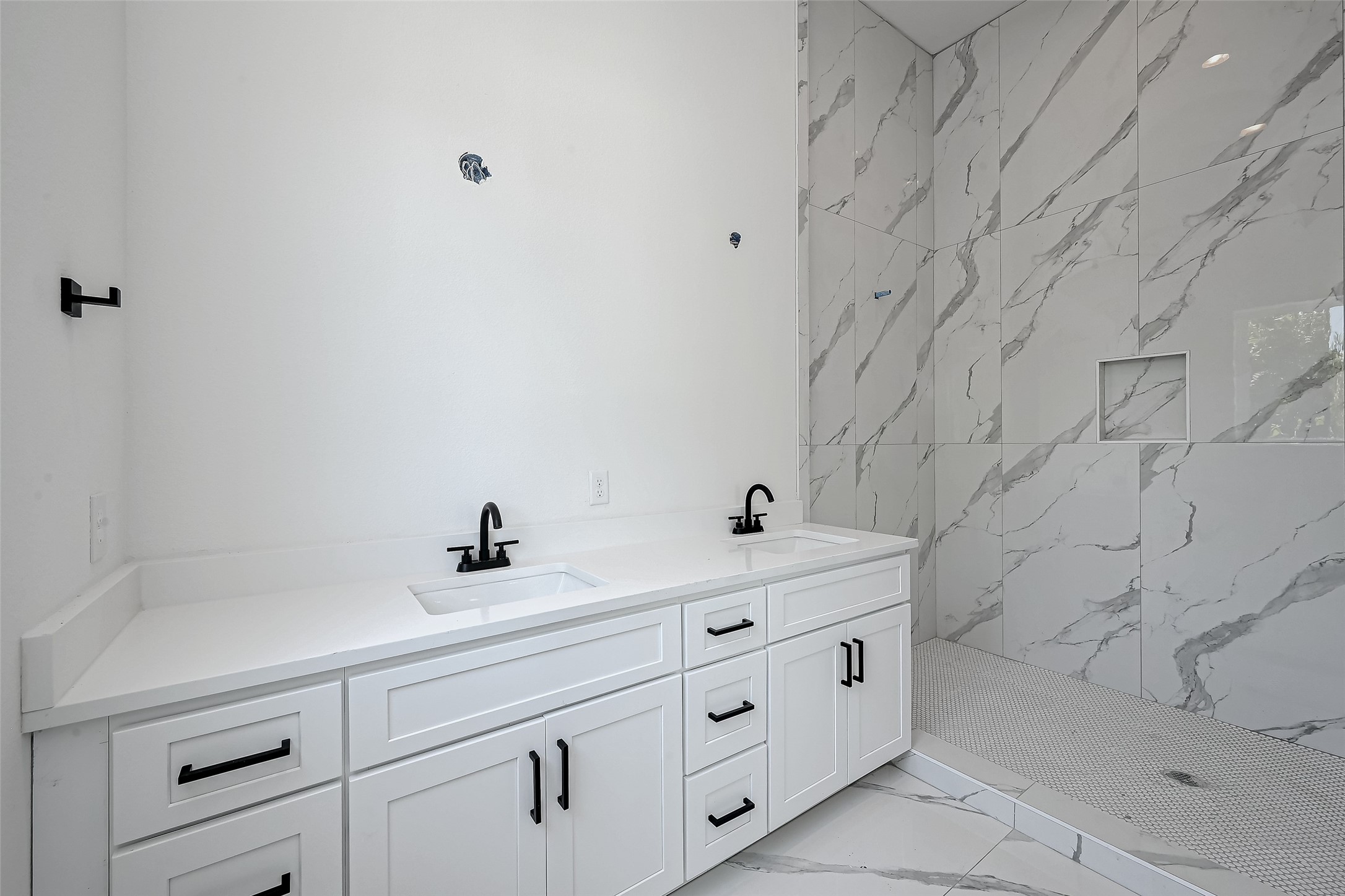 6032 Beall Street Houston, TX 77091 - Photo 18 of 26 Step into luxury with this double vanity bath featuring matte black hardware, quartz countertops, and a spa-like walk-in shower clad in oversized marble-look tile with built-in niche.