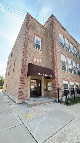 a front view of a building with a garden