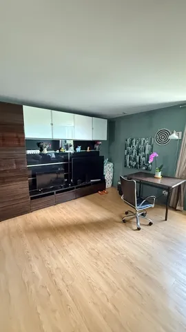 a living room with furniture gym equipment and a ceiling fan