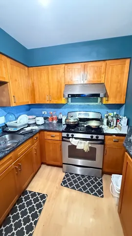 a kitchen with stainless steel appliances a stove a sink and a microwave