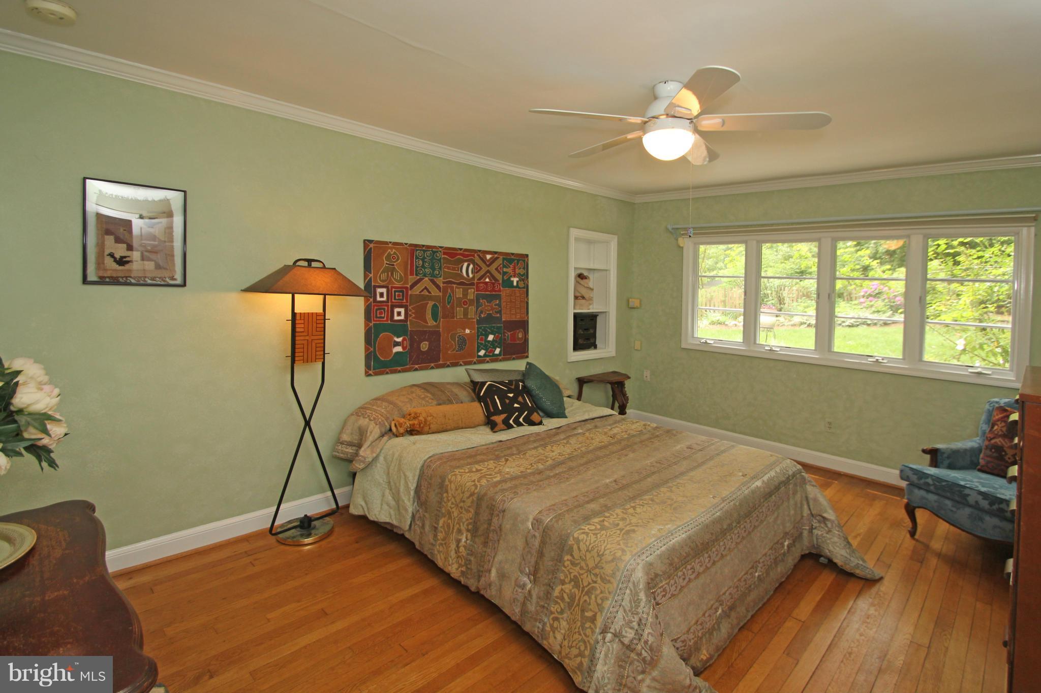 21 Sussex Road Silver Spring, MD 20910 - Photo 13 of 30 a bedroom with a bed and a chandelier