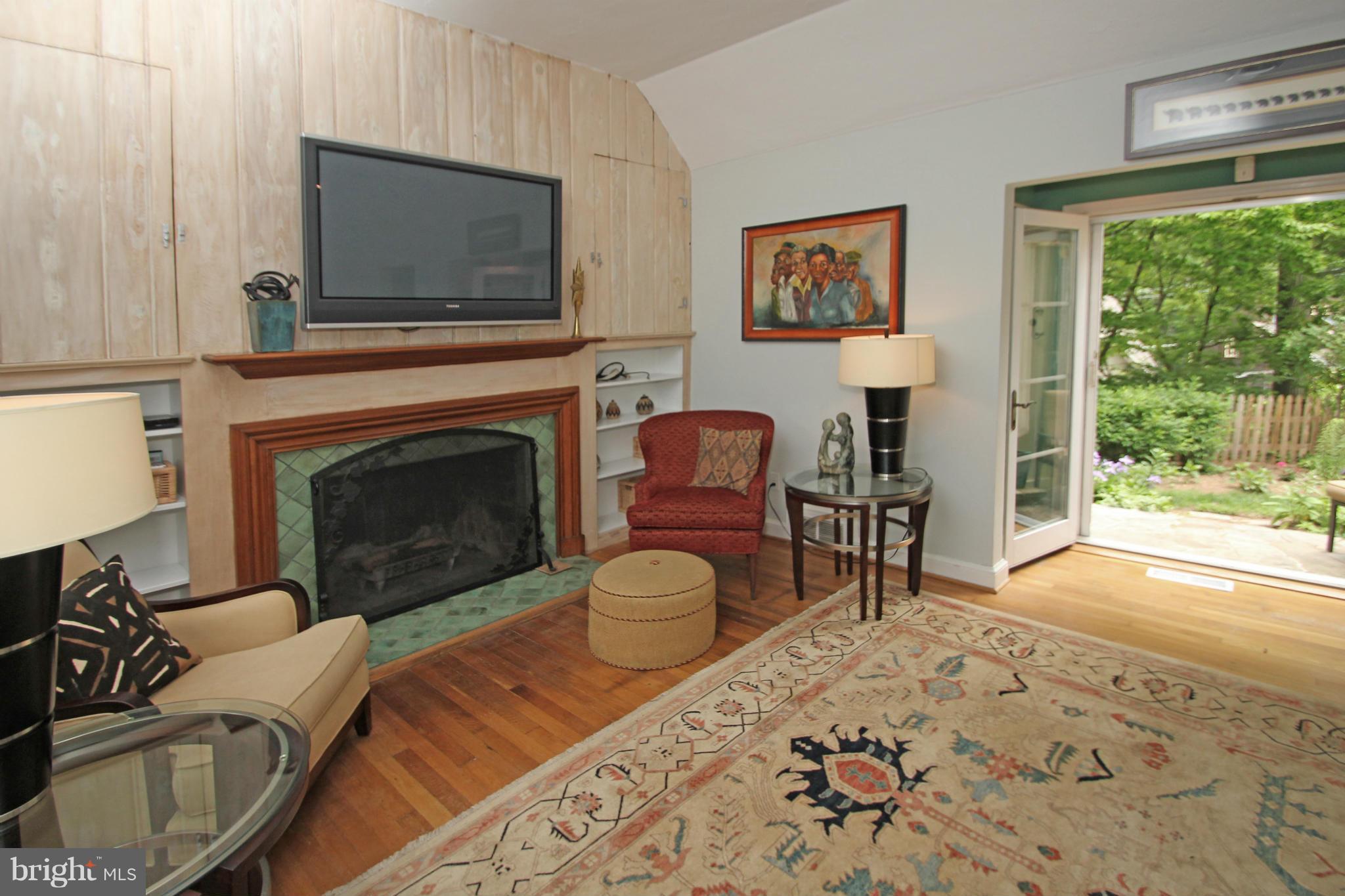 21 Sussex Road Silver Spring, MD 20910 - Photo 6 of 30 a living room with furniture a flat screen tv and a fireplace