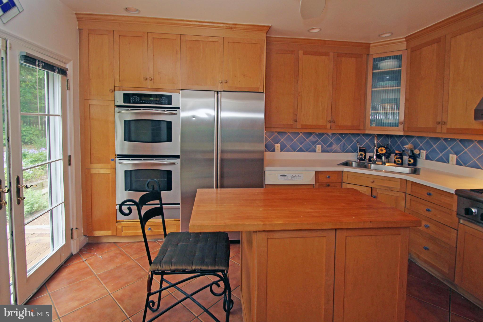 21 Sussex Road Silver Spring, MD 20910 - Photo 9 of 30 a kitchen with a refrigerator a stove a sink and a cabinets