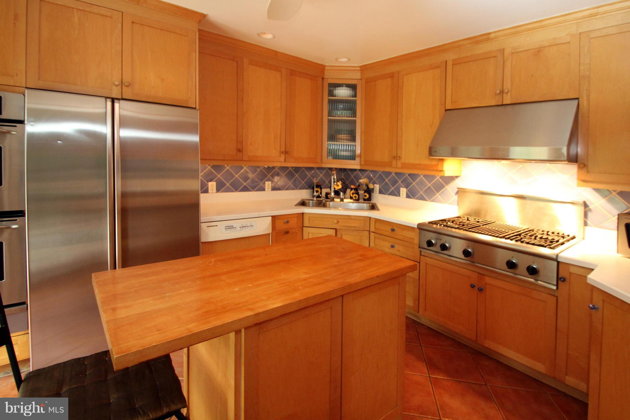21 Sussex Road Silver Spring, MD 20910 - Photo 10 of 30 a kitchen with a sink a stove and a refrigerator