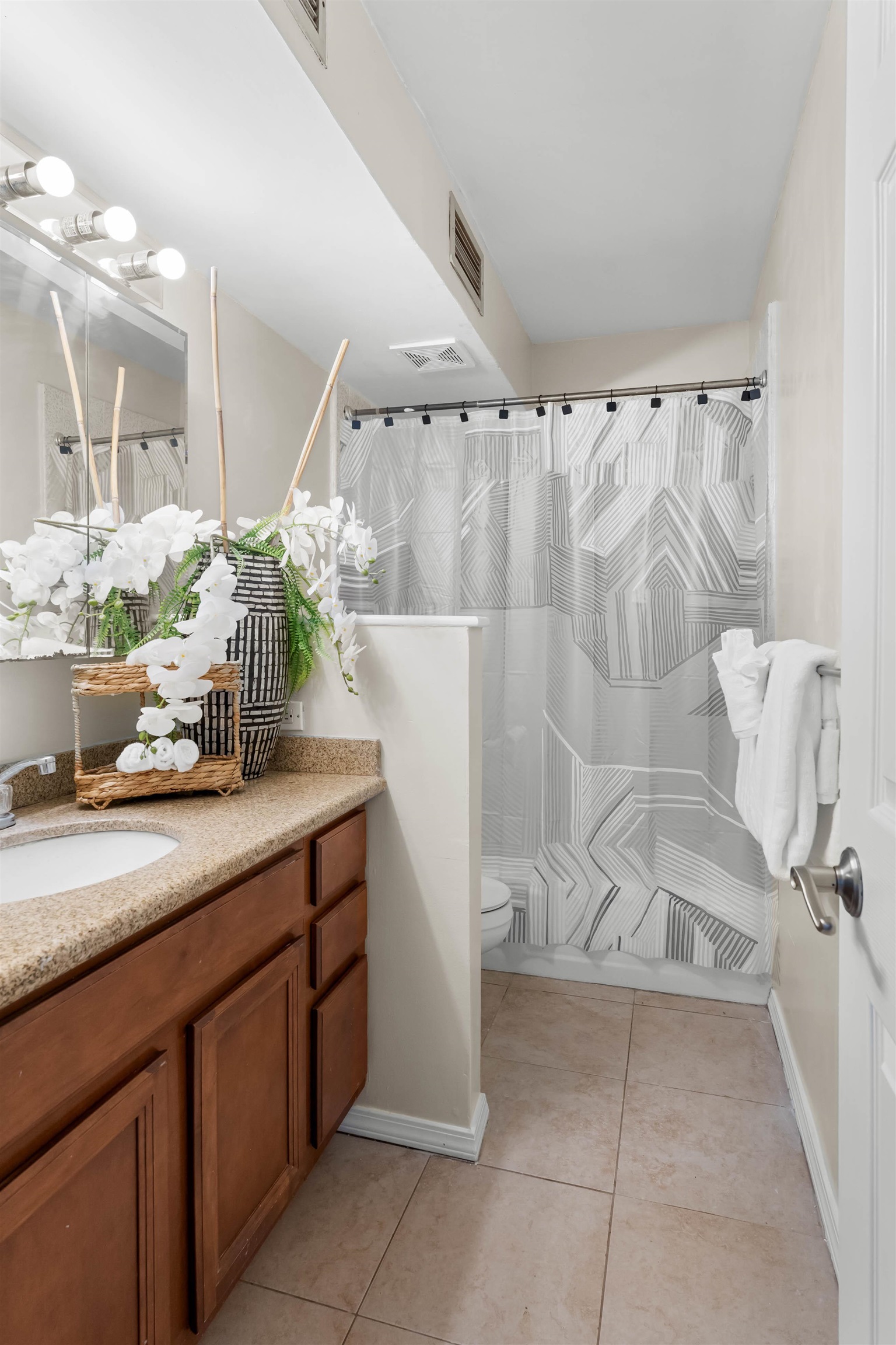 4310 Lower Honoapiilani Road, Unit 609 Lahaina, HI 96761 - Photo 9 of 29 a bathroom with a granite countertop sink a toilet and a shower
