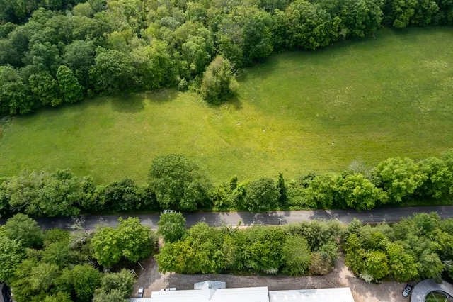 an aerial view of a houses with a yard