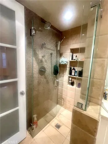 a living room with furniture a table and kitchen view