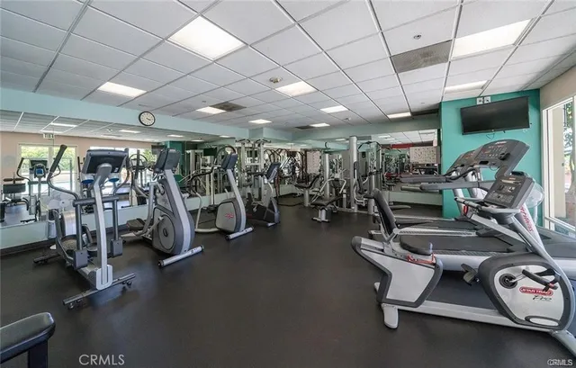 a view of a roof deck with couches and potted plants