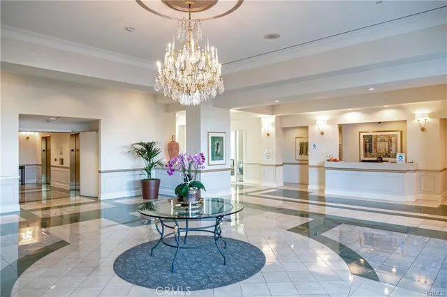 a view of a dining room with furniture a chandelier and wooden floor