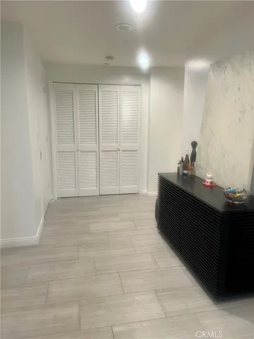 a balcony with wooden floor and outdoor seating