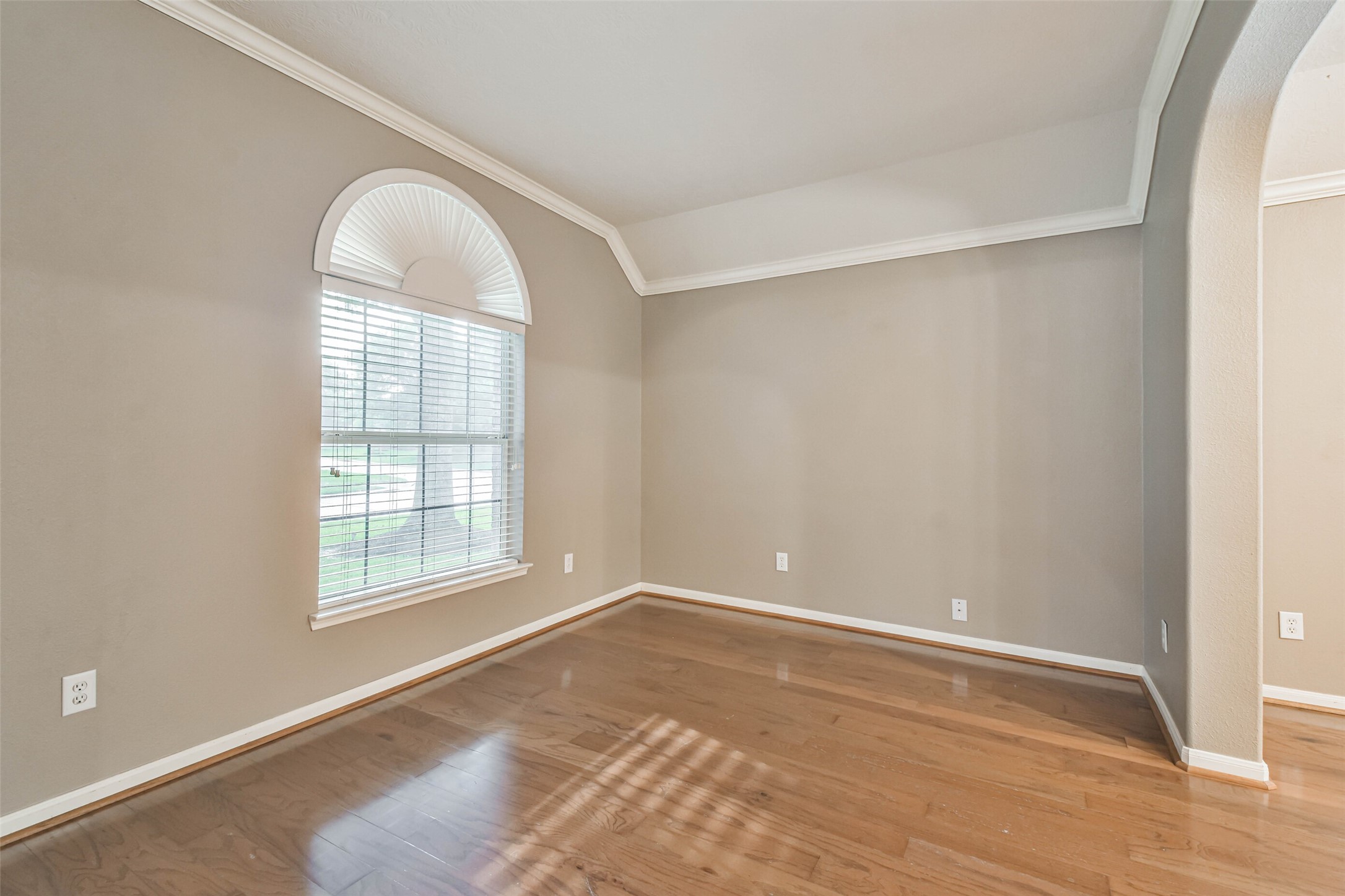 20942 Wind Field Lane Spring, TX 77379 - Photo 8 of 46 an empty room with wooden floor and windows
