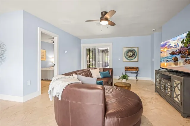 a living room with furniture a rug and white walls