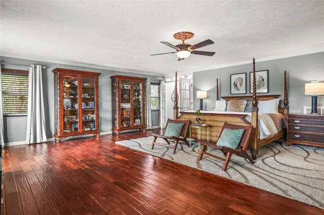 a bedroom with a bed and a painting on the wall