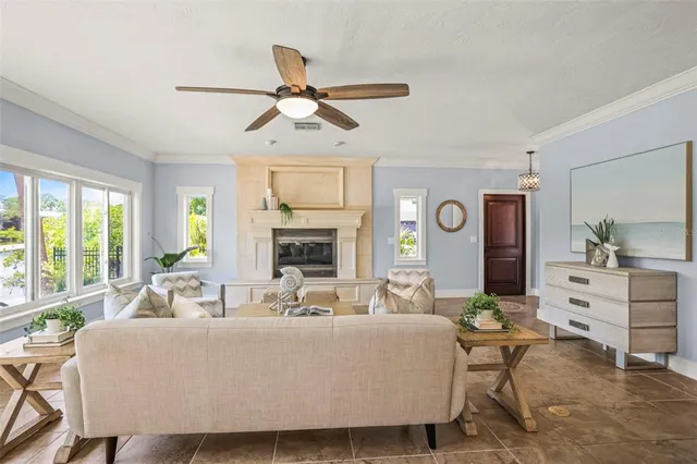 a living room with furniture a fireplace and a large window