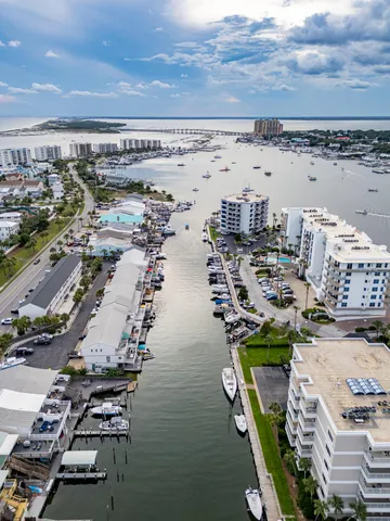 a kitchen with a sink white cabinets and stainless steel appliances