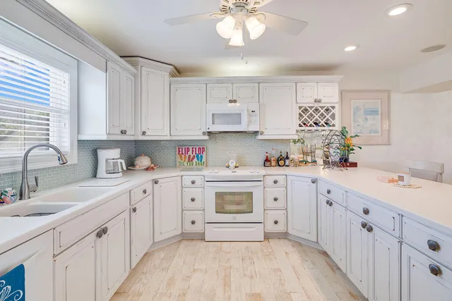 a bedroom with two beds and a painting on the wall