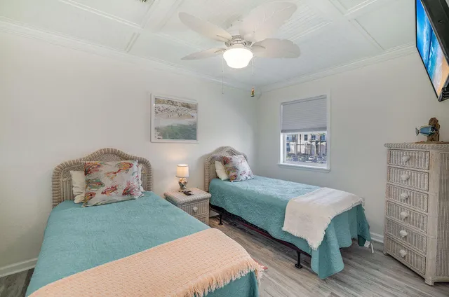 a living room with furniture and a dining table with wooden floor