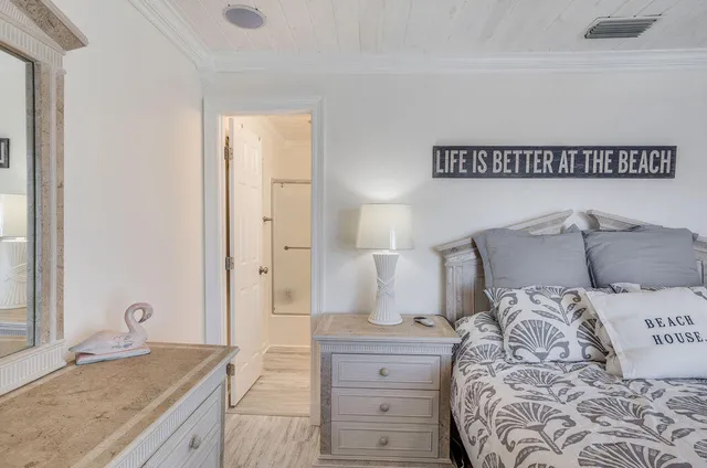 a view of a dining room with furniture a kitchen and chandelier