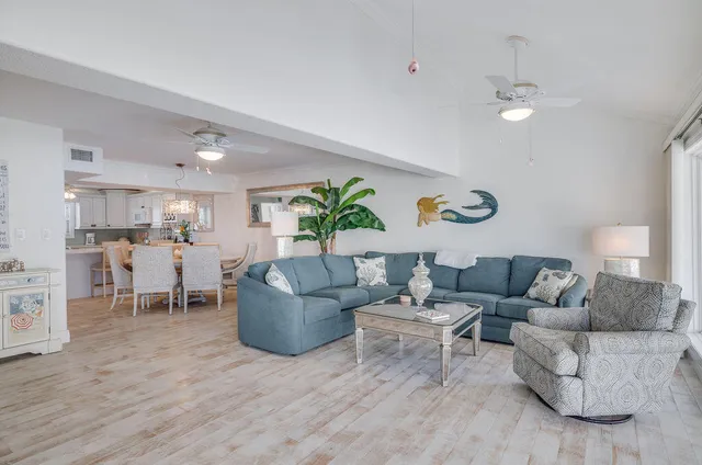 a view of ocean with boats and trees in the background