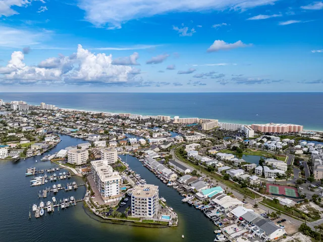 a view of a patio with couches table and chairs and potted plants