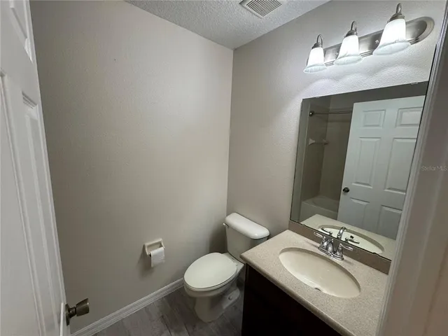 a white bath tub sitting next to a shower