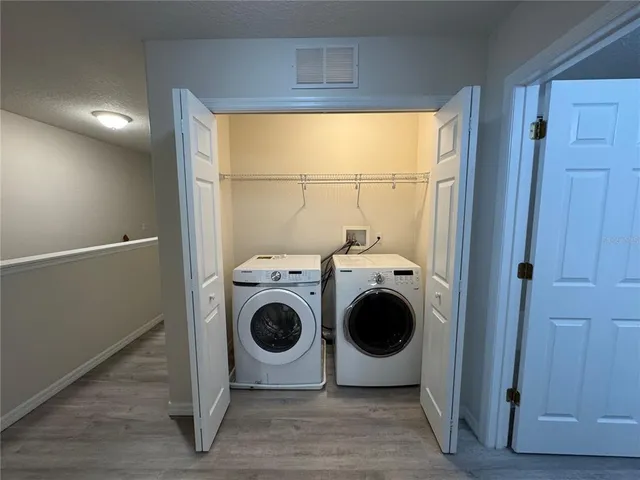 a view of an empty room and wooden floor