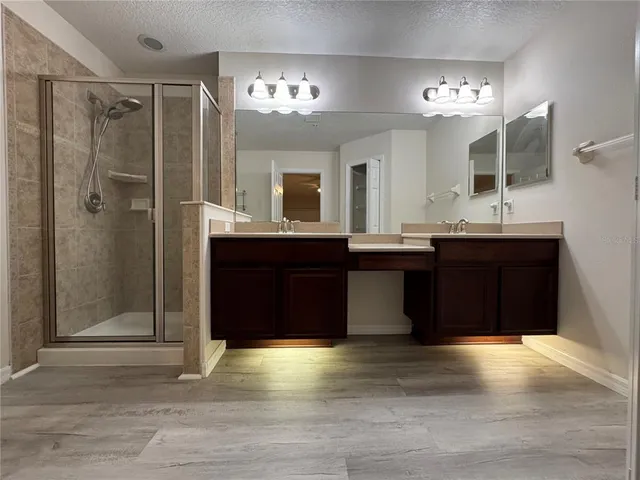 an empty room with wooden floor and a door