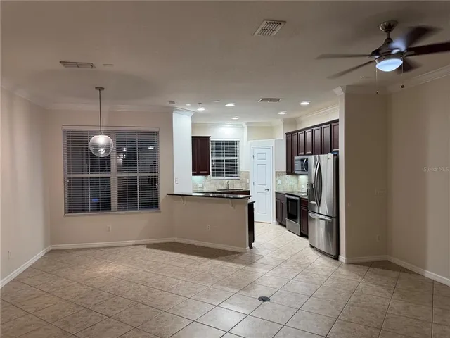 a view of a kitchen with refrigerator and a sink