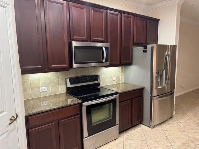a kitchen with a sink and a refrigerator