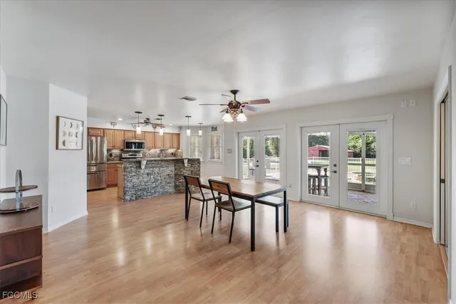 a kitchen with stainless steel appliances granite countertop a stove and a wooden floors