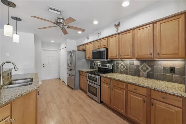 a view of a workspace with furniture and a ceiling fan
