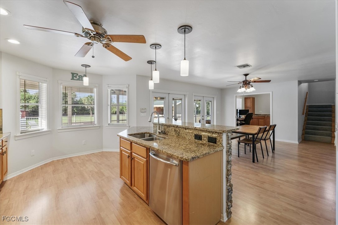 2870 Hickey Creek Road Alva, FL 33920 - Photo 16 of 45 a kitchen with stainless steel appliances granite countertop a stove and a wooden floors