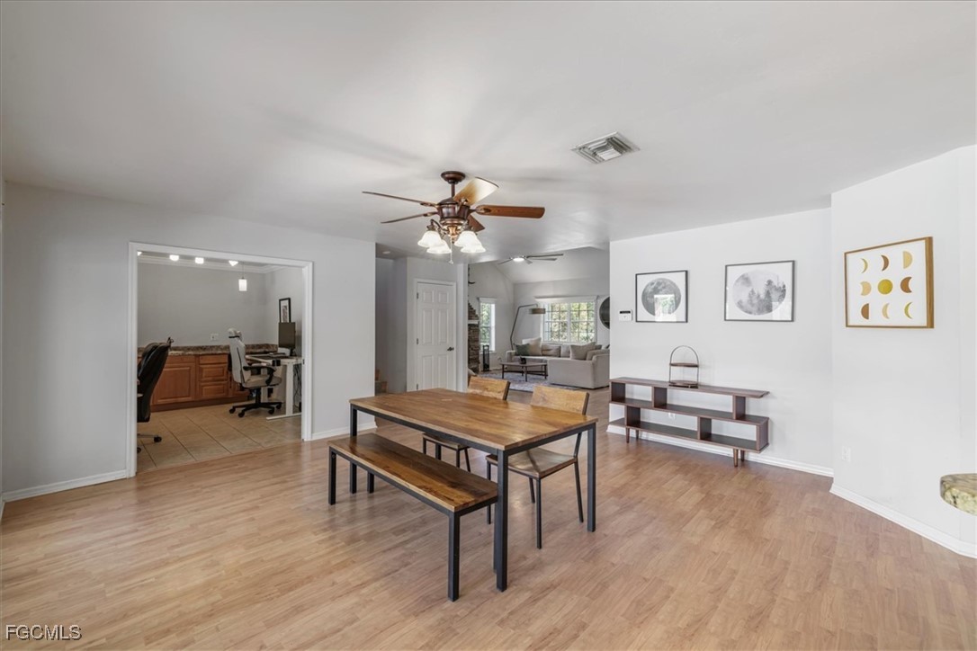 2870 Hickey Creek Road Alva, FL 33920 - Photo 17 of 45 a living room with furniture and wooden floor