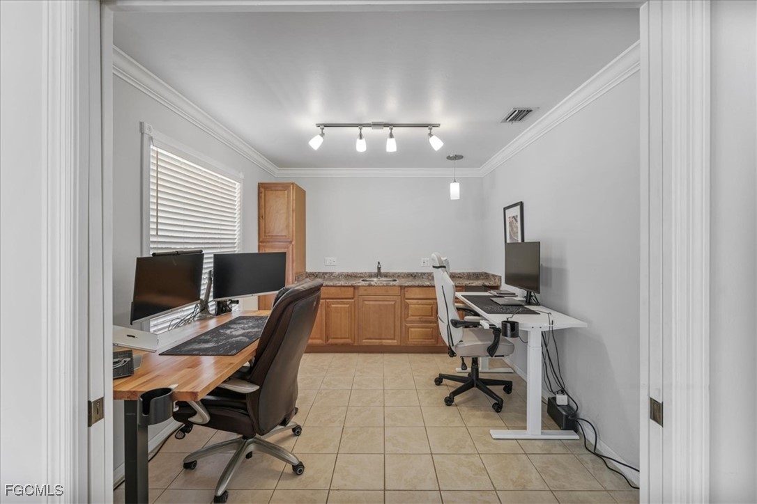 2870 Hickey Creek Road Alva, FL 33920 - Photo 19 of 45 a view of a workspace with furniture and a ceiling fan