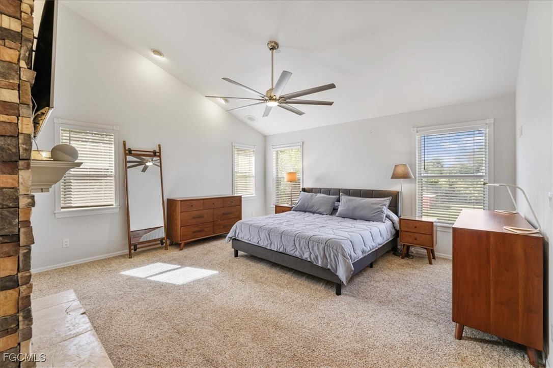 2870 Hickey Creek Road Alva, FL 33920 - Photo 22 of 45 a spacious bedroom with a bed dresser and a window