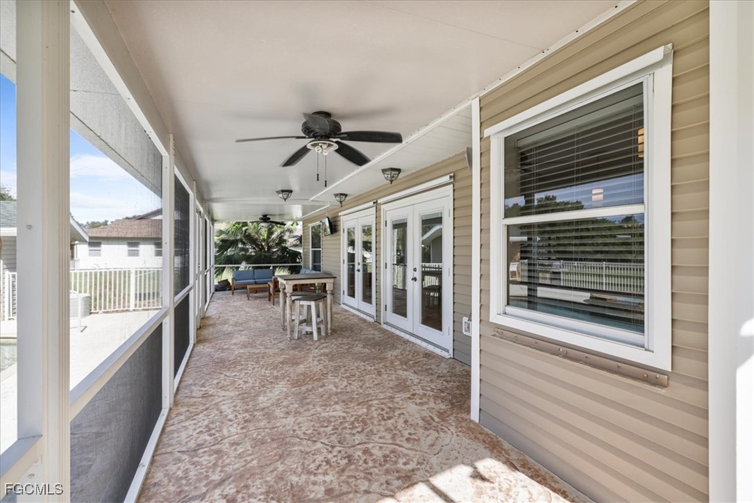 2870 Hickey Creek Road Alva, FL 33920 - Photo 31 of 45 a view of a porch with furniture and floor to ceiling window