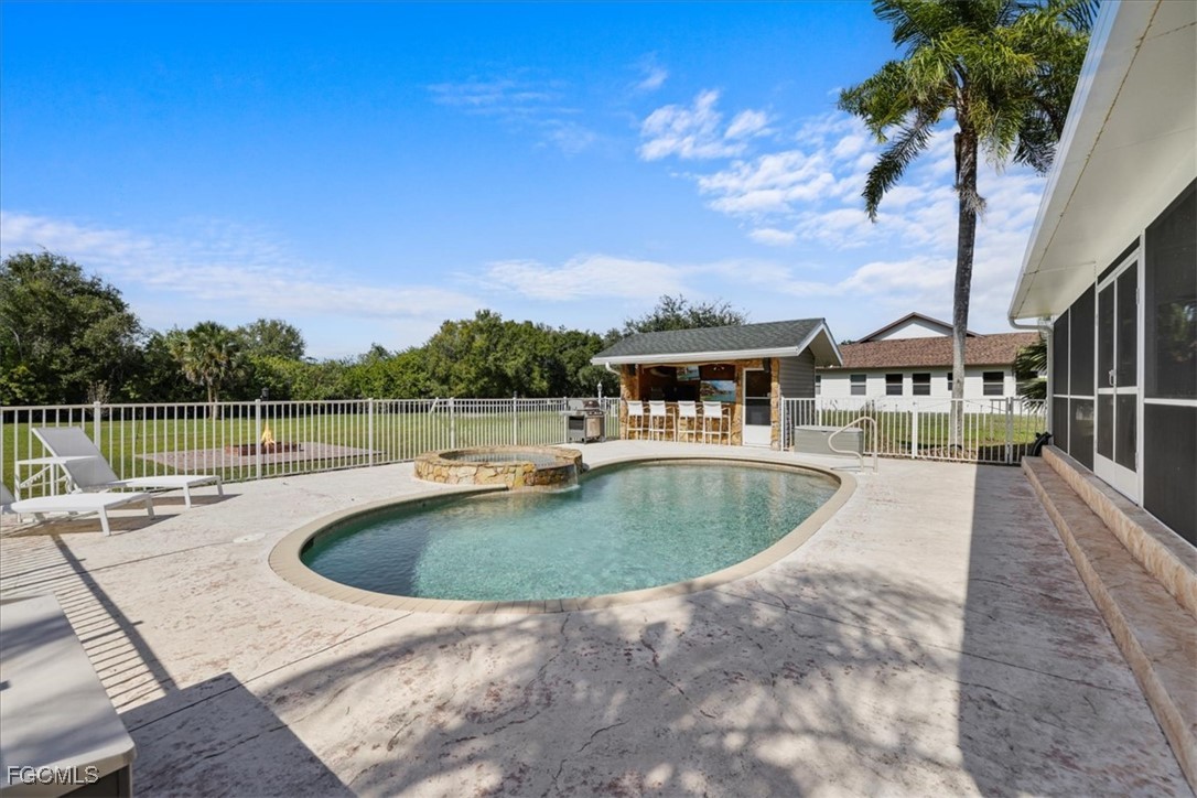 2870 Hickey Creek Road Alva, FL 33920 - Photo 34 of 45 a view of a house with a swimming pool