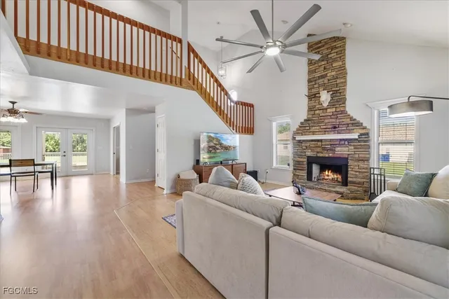 a living room with furniture a fireplace and a chandelier