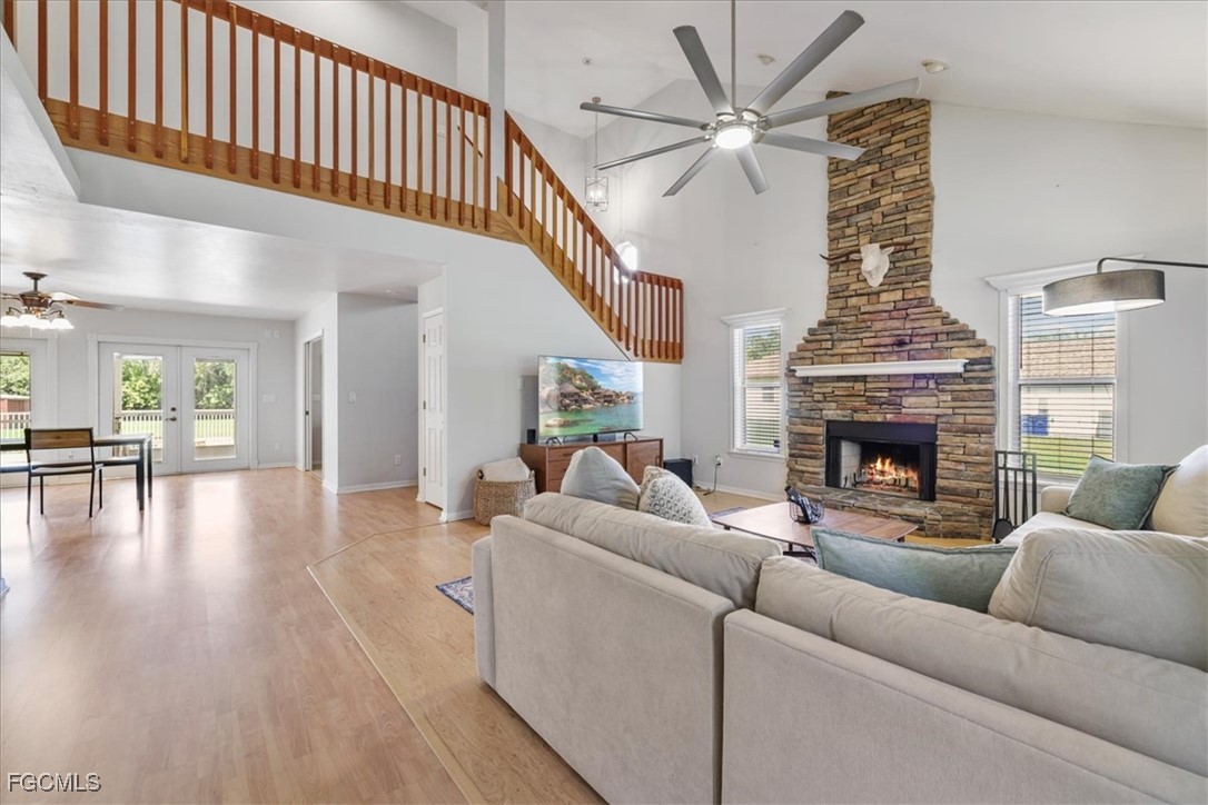 2870 Hickey Creek Road Alva, FL 33920 - Photo 5 of 45 a living room with furniture a fireplace and a chandelier