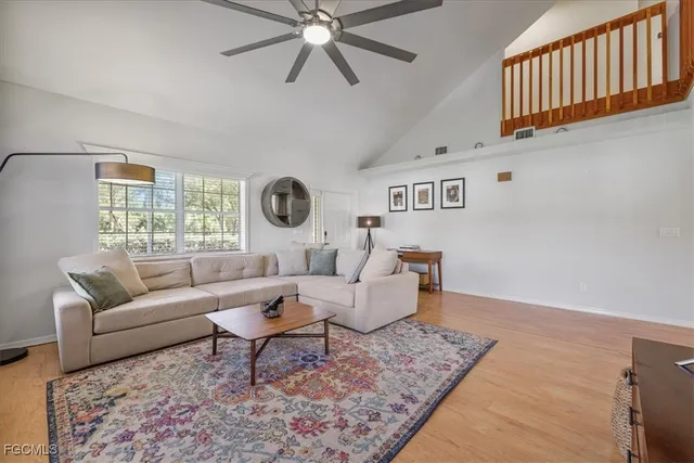 a living room with furniture and kitchen view