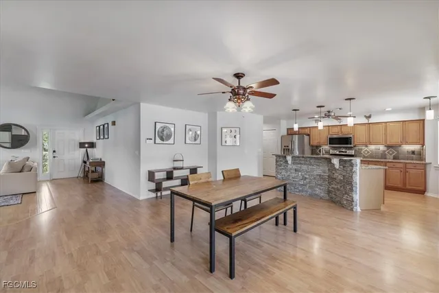 a large kitchen with kitchen island granite countertop a large counter top stainless steel appliances and cabinets