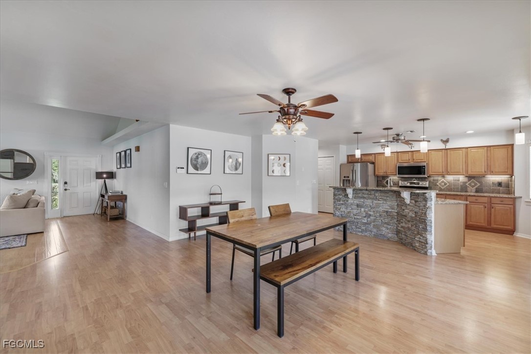 2870 Hickey Creek Road Alva, FL 33920 - Photo 9 of 45 a living room with furniture and kitchen view
