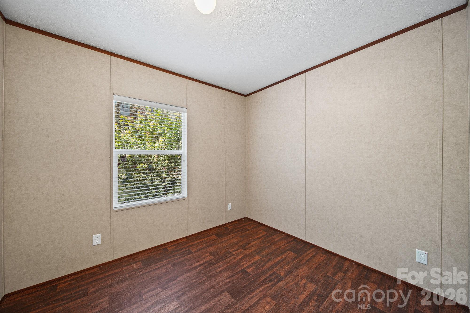4507 White Store Road Wingate, NC 28174 - Photo 25 of 29 a view of an empty room with wooden floor and a window