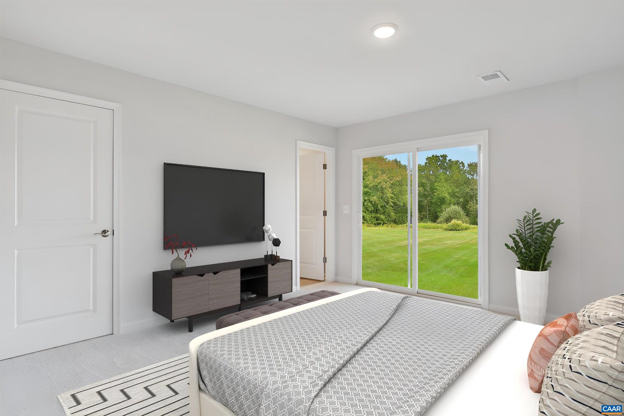2990 Rambling Brk Lane Crozet, VA 22932 - Photo 27 of 44 a bedroom with a bed and a flat tv screen next to a window
